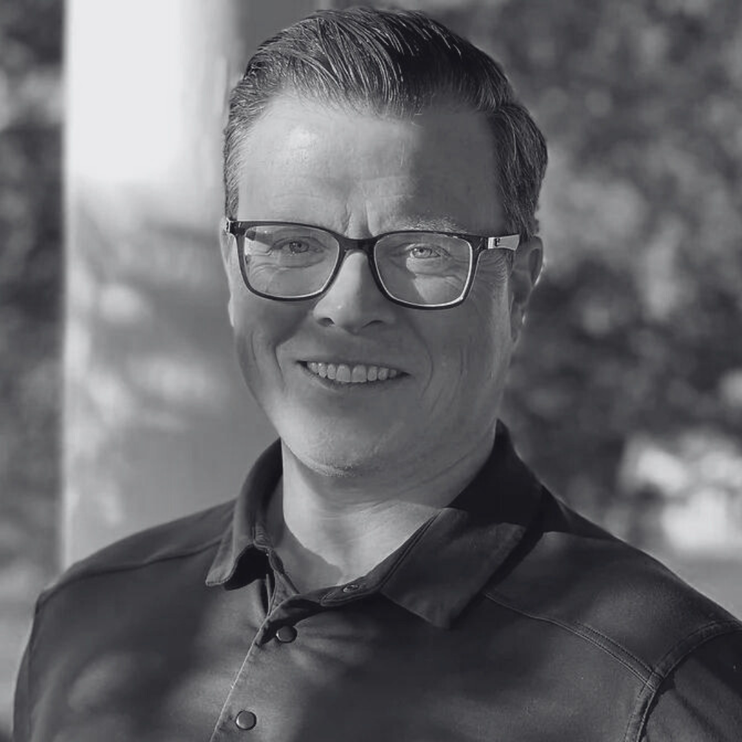 black and white headshot of BROCK LUPTON, VP Cyber Intelligence Operations at Sapper Labs Group Inc.